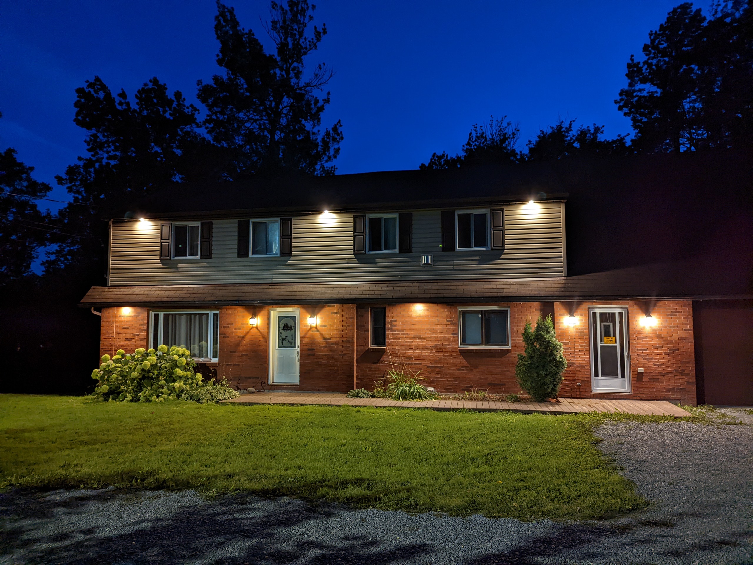 Main residence — two-storey brick and siding home, evening exterior