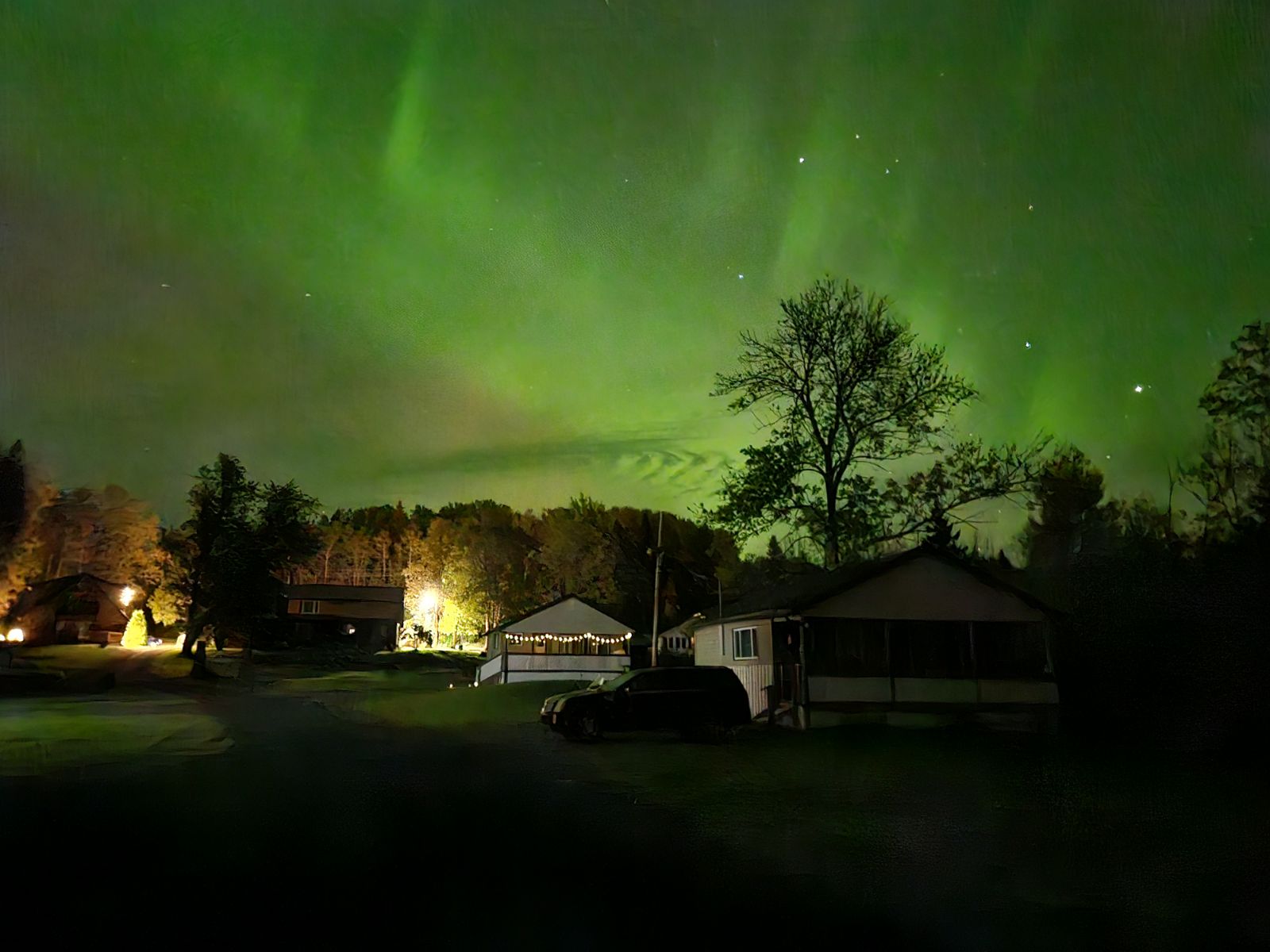 Aurora borealis — green and luminous over the Property at night, viewed from the lawn